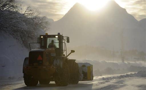 Snow and ice are plowed on a Valdez roadway, Saturday, Jan. 14, 2012 in Valdez, Alaska. The city of Valdez continues to dig out from more than 322 inches of snow this winter. That's 168 inches above a normal winter snowfall, the National Weather Service said. (AP Photo/The Anchorage Daily News, Marc Lester)